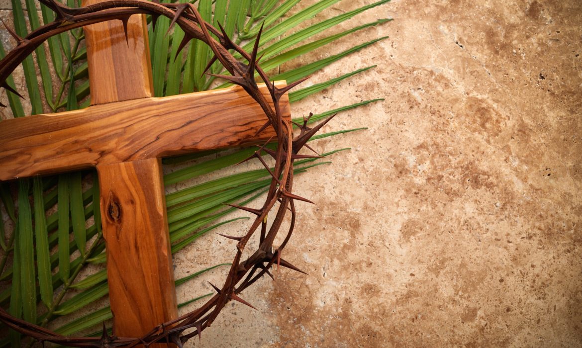 Crown of thorns, cross and palm leaves. Palm sunday and easter day concept.